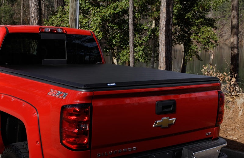 Lund 04-15 Nissan Titan (5.5ft. Bed) Hard Fold Tonneau Cover w/Bracket Kit - Black